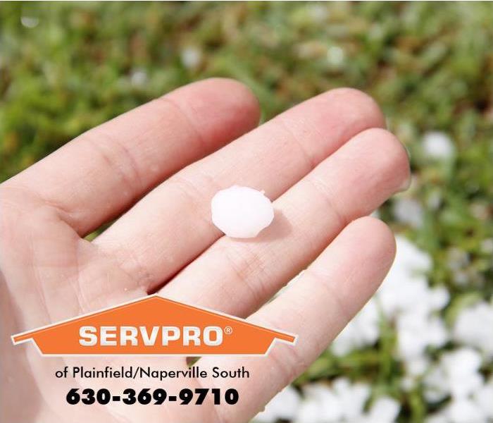 A person is holding a hail stone in their hand.