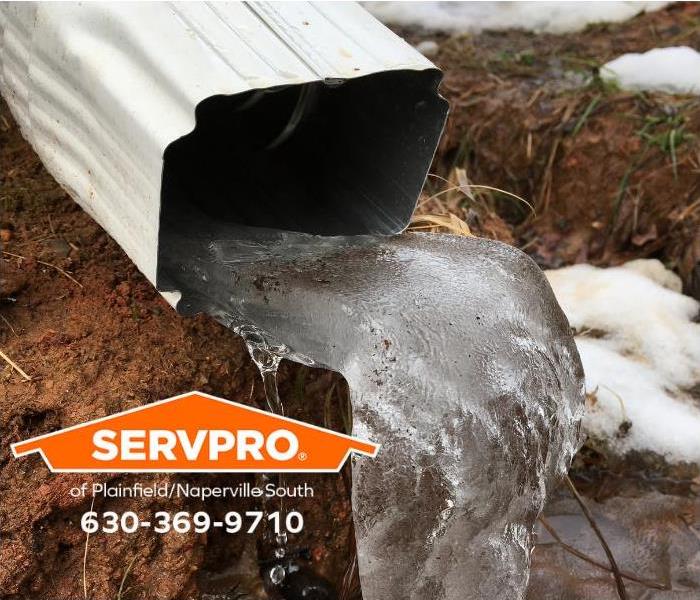 A misdirected downspout causes soil erosion.