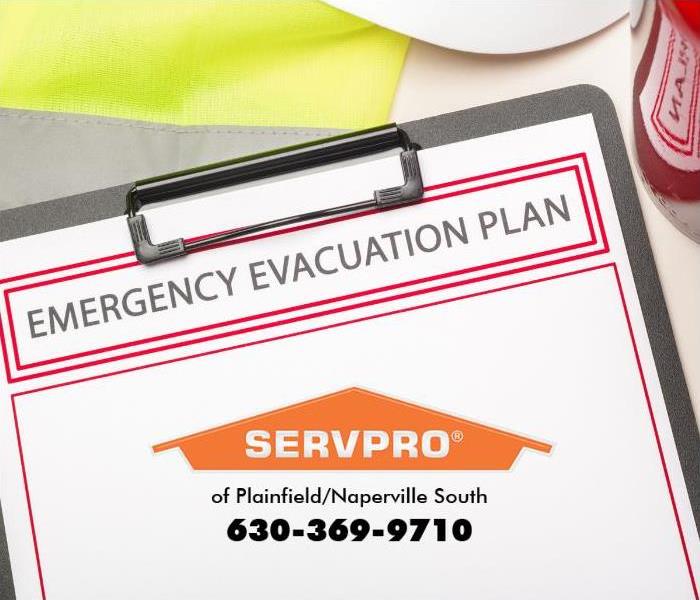 An evacuation plan sits on a clipboard on a table.
