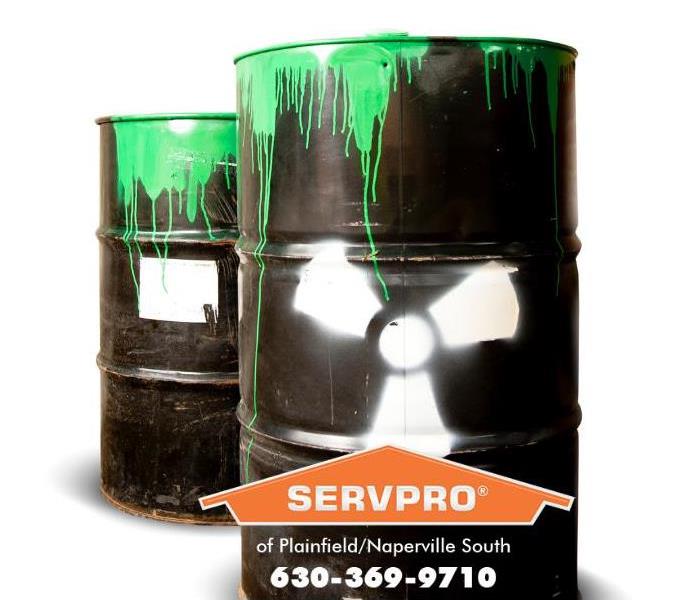 Two large toxic waste containers are shown with green fluid spilling down the side.